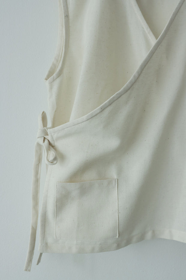 Close-up of side seam and waist tie of hemp cotton wrap top, shows clean stitching and texture of eco-friendly material