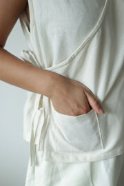 Close-up of handmade hemp cotton wrap top with front pocket, lightweight, breathable fabric ideal for conscious everyday wear