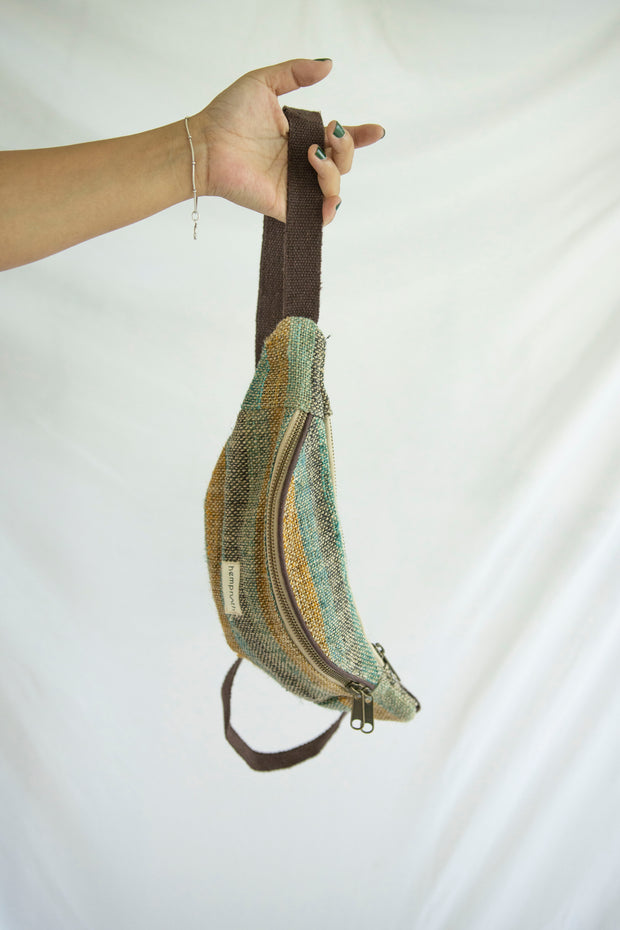 A vibrant striped hemp waist bag, sustainably crafted with multiple pockets and an adjustable strap for versatile wear.