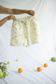 natural shorts with two pockets that have floral natural dye