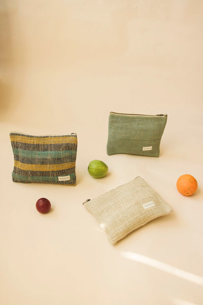 Set of natural hemp pouch bags arranged with fruit for an eco-conscious vibe