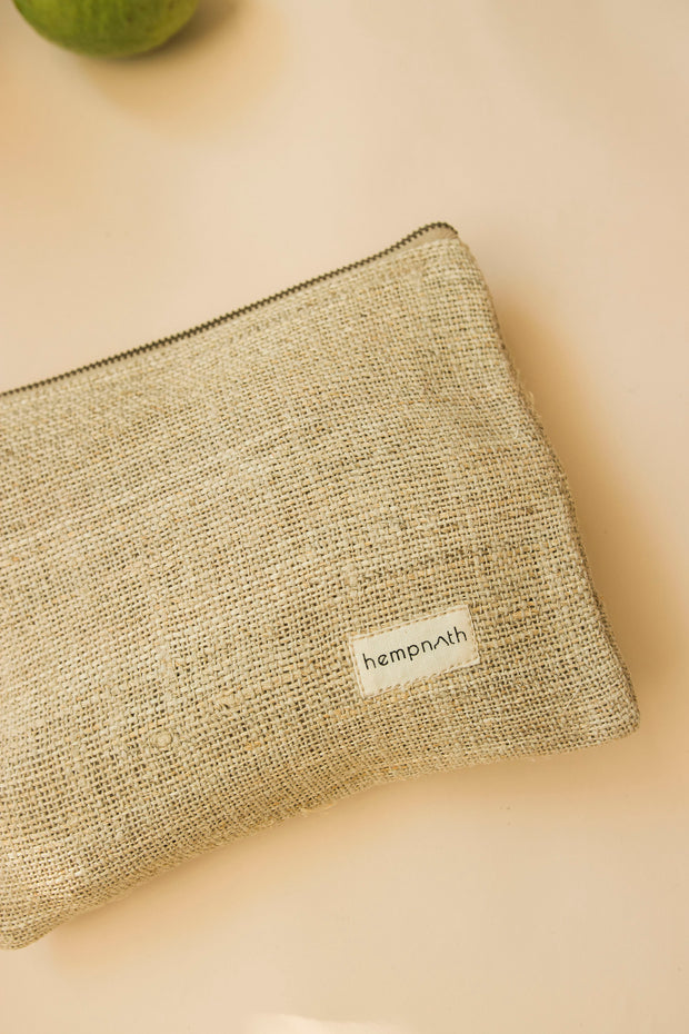 Hemp pouch bag with textured weave presented on a warm neutral surface