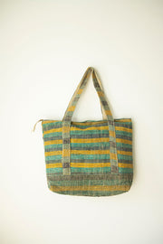 Natural tote bag hanging flat against a wall, made from eco-friendly hemp in soft earthy tones