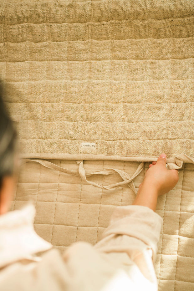 Close-up of hand inspecting the mat's stitching and padding.
