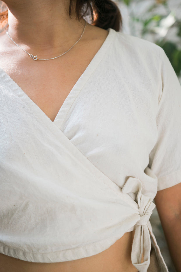 Eco-friendly Dija wrap top made from hemp and cotton blend, in a natural, undyed color.