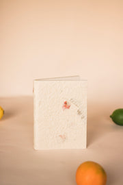 Handcrafted A6 notebook with a cover adorned with pressed Bougainvillea and Marigold petals