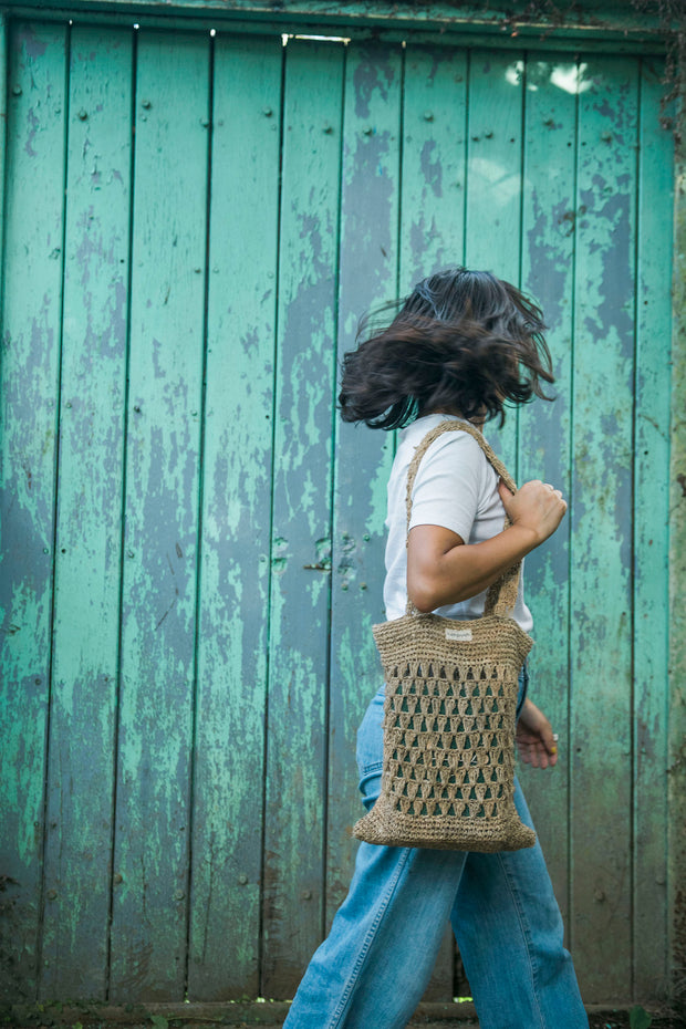 Knitted bag perfect for casual outings and sustainable fashion enthusiasts, blending utility with an earthy aesthetic.