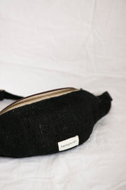 A classic black hemp waist bag, sustainably made with an adjustable strap and secure compartments.