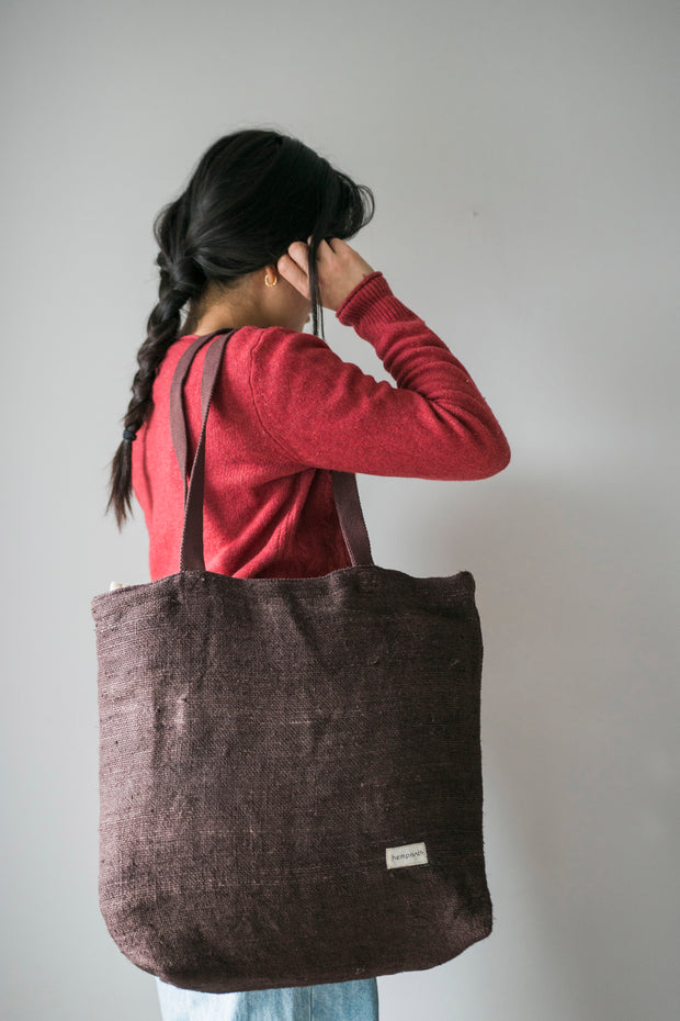 brown tote bag in large size, carried by a woman 