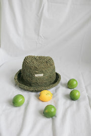 A naturally dyed moss green bucket hat crafted from sustainable hemp. Hand-knitted with care, offering a stylish and eco-conscious choice for casual wear.