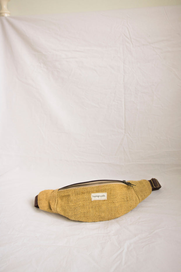 A bold mustard-colored hemp waist bag, featuring durable handcrafted design and ample storage space