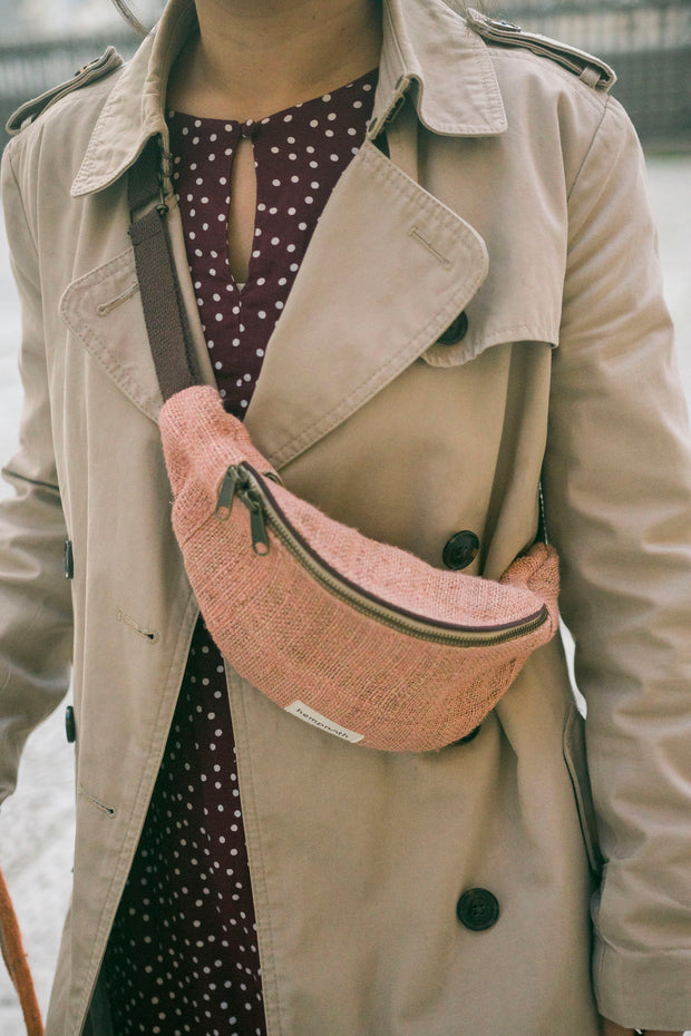 A playful pink hemp waist bag, handmade from sustainable materials, perfect for adding a pop of color to your outfit.