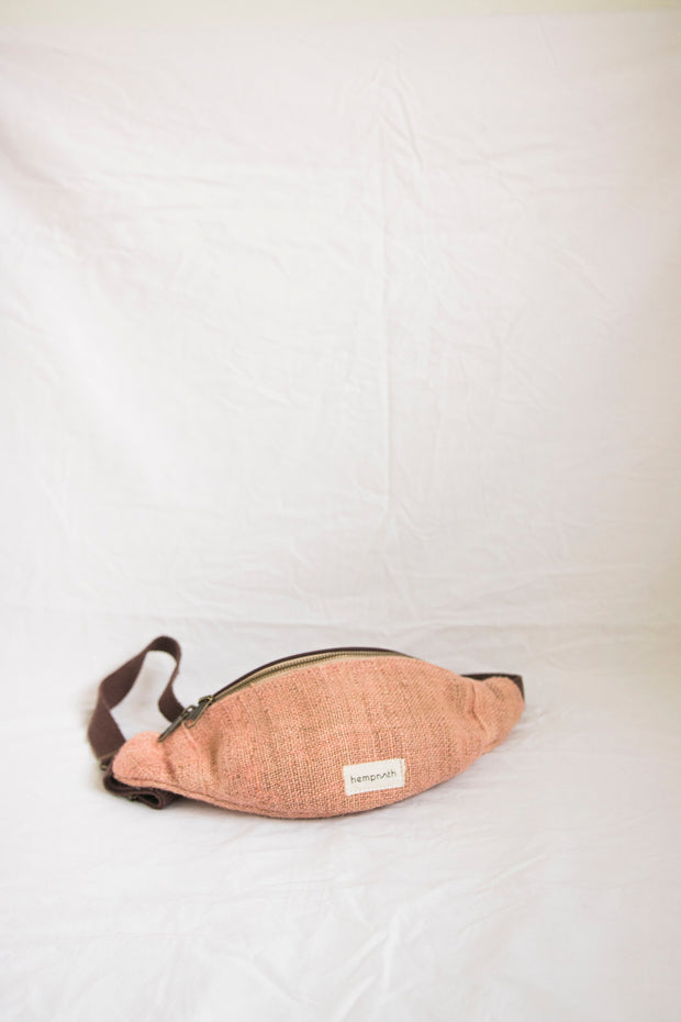 A playful pink hemp waist bag, handmade from sustainable materials, perfect for adding a pop of color to your outfit.